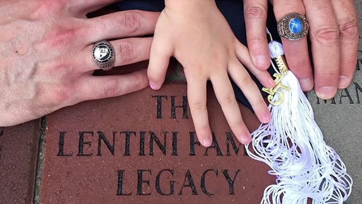 The Lentini family place their hands over a donated legacy brick